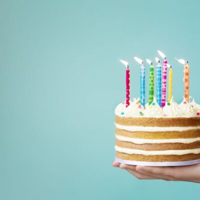 Birthday cake with buttercream and colorful candles